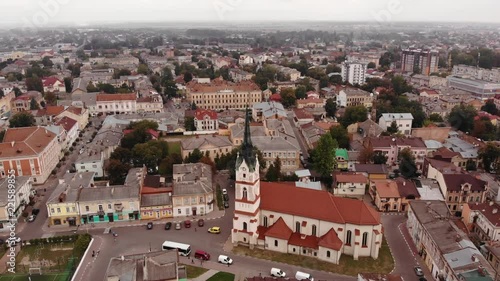Aerial view of Stryi city architecture with fly around old Church of Our Lady Protectress, Ukraine, 4k