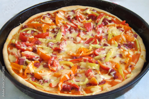 Delicious homemade pizza with sweet pepper, sausage, cheese and sauce. Cook at home