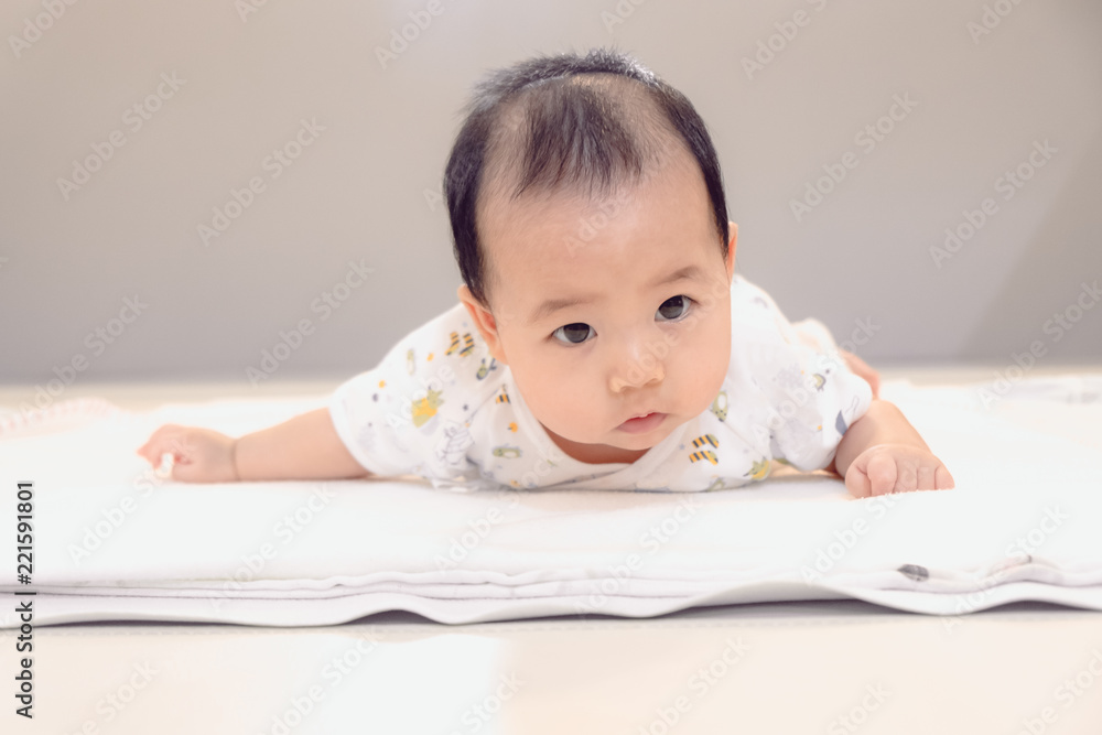 Asian baby girl lying on the bed, Baby development stages of 3 month.. Asian baby girl lying on the bed, Baby development stages of 3 month..