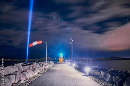 Lighthouse and Imagine Peace Tower on Videy island in Reykjavik at night photo