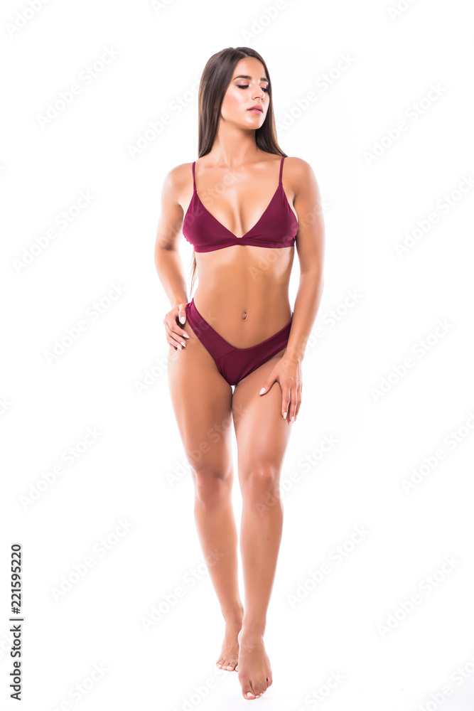 Full length portrait of young woman wearing bikini, isolated on white. Concept of summer holidays and traveling Full length portrait of young woman wearing bikini, isolated on white. Concept of summer holidays and traveling