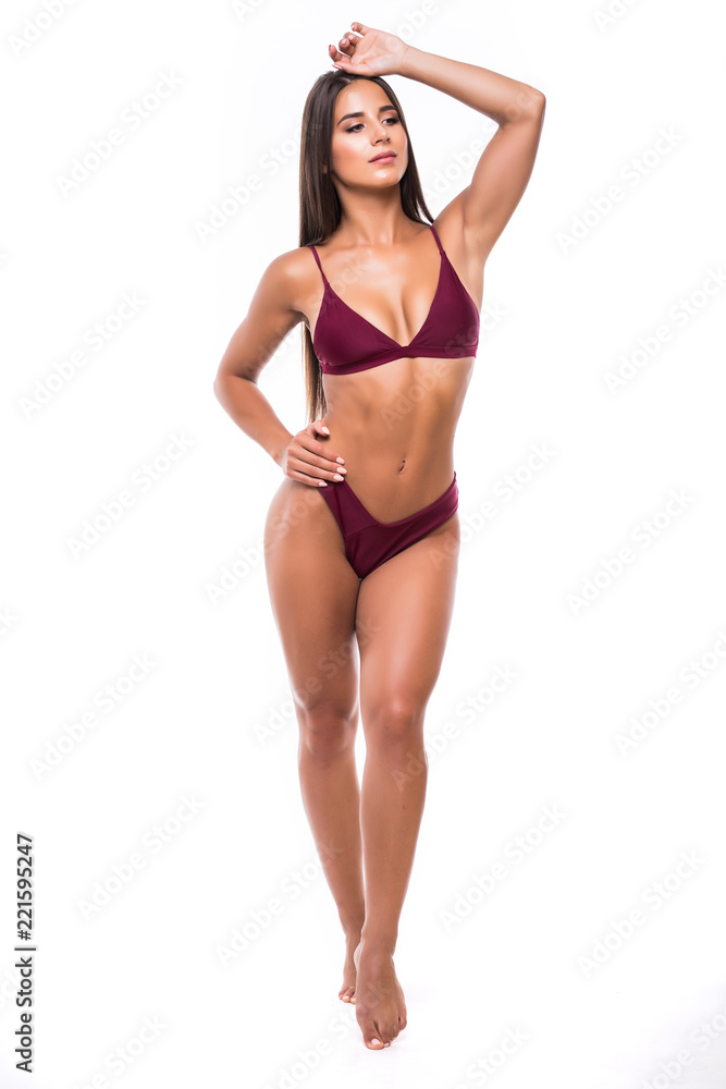 Full length portrait of young woman wearing bikini, isolated on white. Concept of summer holidays and traveling Full length portrait of young woman wearing bikini, isolated on white. Concept of summer holidays and traveling