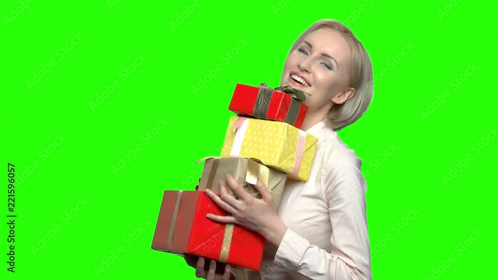 Woman with gift boxes. Green hromakey background for keying. Woman with gift boxes. Green hromakey background for keying.