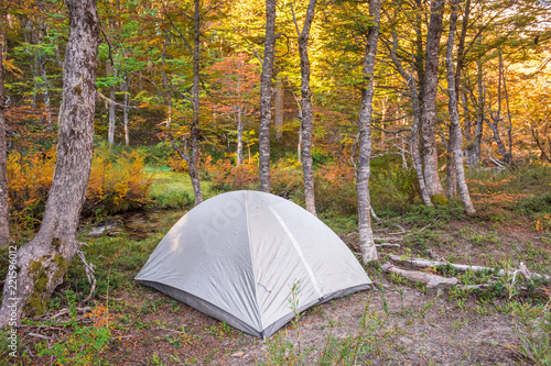 Grey silver tent in a remote wild campsite in the mountains with copy space for text / Camping gear and equipment / Camp in the forest in autumn / Patagonia Argentina