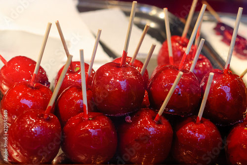 Sweet candy Apple. Sweets  glazed paradise apples on sticks for sale on farmer market or country fair. Sugar apple with red icing.