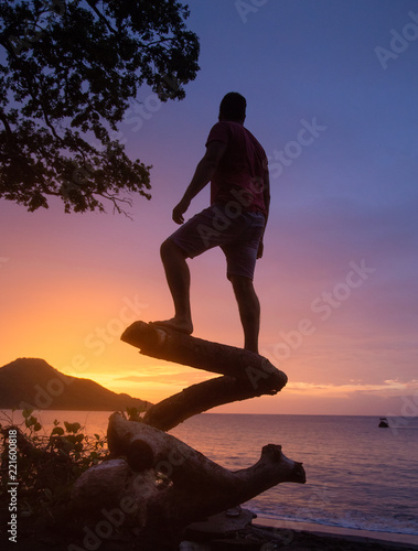 man watching the sunset in the Pacific Ocean in Guanacaste Costa Rica