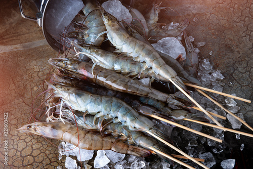 Skewer raw shrimps or prawns.