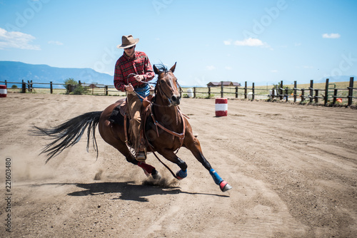 Cowboy Showcasing Barrel Racing Skills on Horseback photo