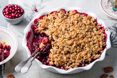 Cranberry crumble, crisp in a baking dish. Grey background. Close up.