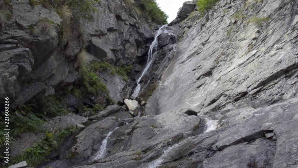 Little waterfall in a wood in the Alps in summer Little waterfall in a wood in the Alps in summer