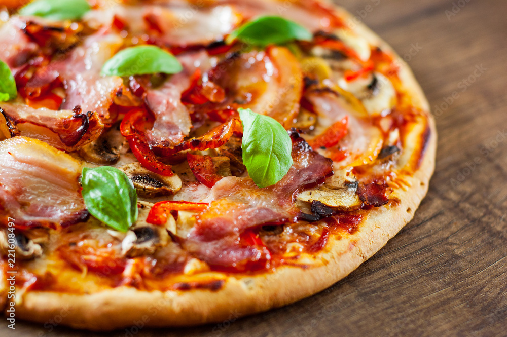 Pizza with Mozzarella cheese, mushrooms, bacon, Tomatoes, pepper, Spices and Fresh Basil. Italian pizza on wooden background. Pizza with Mozzarella cheese, mushrooms, bacon, Tomatoes, pepper, Spices and Fresh Basil. Italian pizza on wooden background.