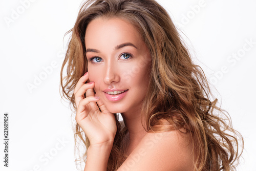 Beauty Woman face Portrait. Beautiful Spa model Girl with Perfect Fresh Clean Skin.  female looking at camera  on white isolated background. Beautiful hairstyle Youth and Skin Care Concept