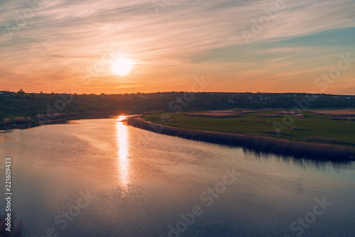 sunset in dramatic sky over river