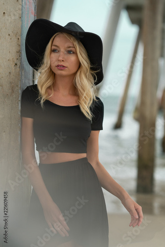 Portrait of young blond girl with hat at beach