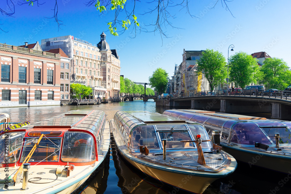 canal in the center of Amsterdam with Munt tower, Netherlands