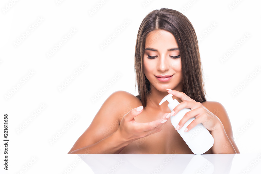 Young woman pouring body lotion on hand isolated on white background. Skincare Young woman pouring body lotion on hand isolated on white background. Skincare