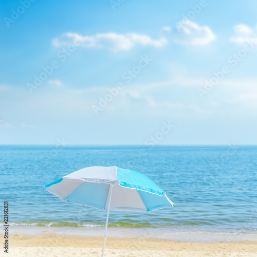 umbrella on the sea beach under blue sky with clouds