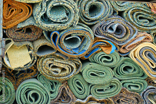 Disposed rolls of carpet padding.