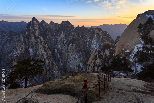 Huashan Sunset, Mount Hua - Huayin, near Xi'an in Shaanxi Province China. Cliff Scenery with Steep Vertical Drop-off, Yellow granite mountains of China. Chinese Temple attached to mountain cliffs photo