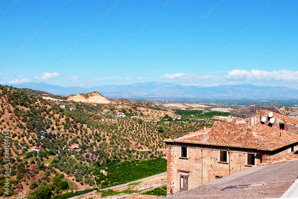 Panorama of southern Italy mountains with olive groves and small villages..