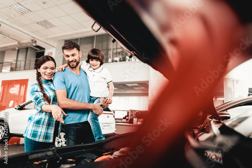 Young Family Are Choosing A New Car In Showroom. © VadimGuzhva