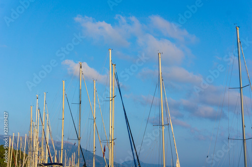 A group of mast against cloudscape