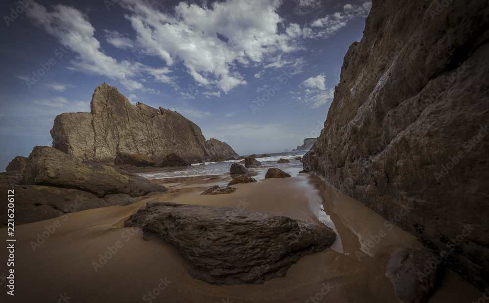 Travel, Beach with rocks in summer. Playa de la Arnía in Santander, Spain