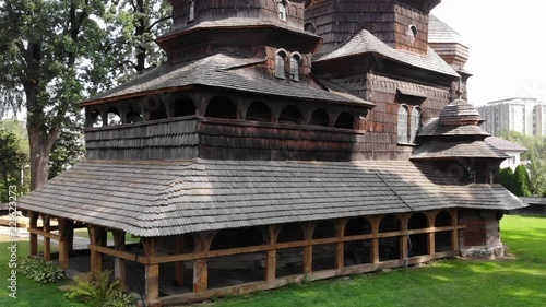 Ancient wooden St. Georges Church in Drohobych, Ukraine. World heritage site. Aerial view, smooth flight up with panoramic view of the Drohobych city