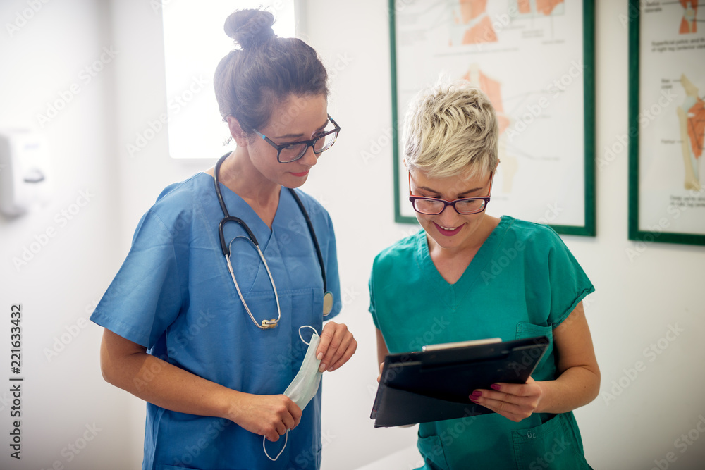 Professional nurses looking through some patients medical papers. Professional nurses looking through some patients medical papers.