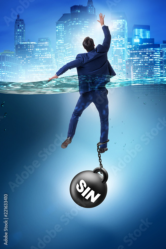 Fotografia Businessman drowning under the burden of sin and guilt