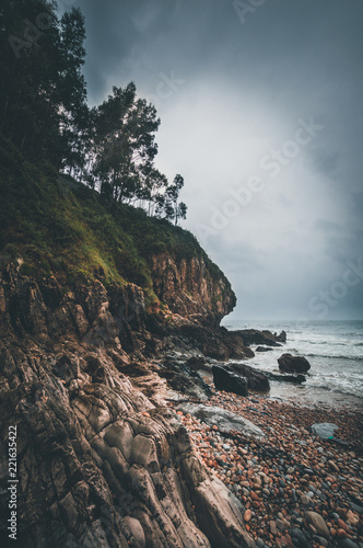 Beach with rocks and cloudy day