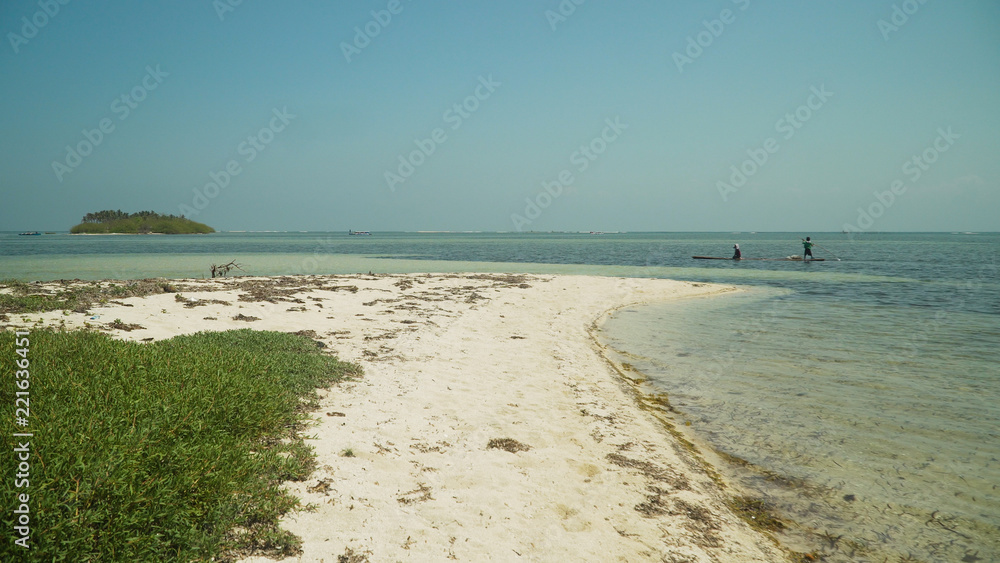 Fototapeta premium Tropical island with white sandy beach in blue lagoon. Tondol white sand beach with turquoise water. Seascape, ocean and beautiful beach. Philippines, Anda, Pangasinan. Travel concept.