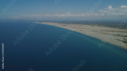 Aerial view of seashore with beaches, lagoons and coral reefs. Philippines, Luzon, Ilocos Norte. Coast ocean with turquoise water. Tropical landscape in Asia.