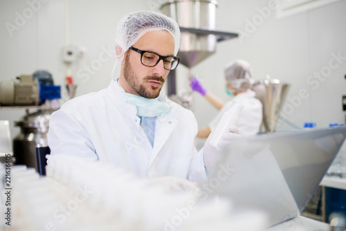 Hard working lab employee working on a computer.