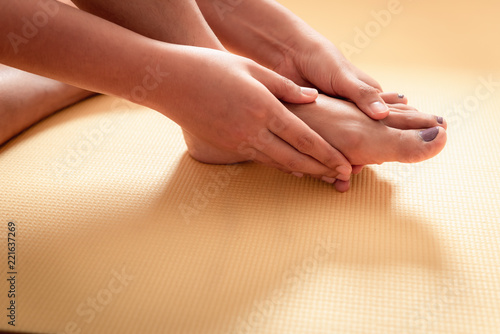 Closeup of young woman massaging her feet, Healthcare concept