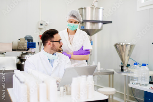 Two laboratory employees discussing about test results.