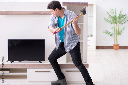 Man trying to fix broken tv photo