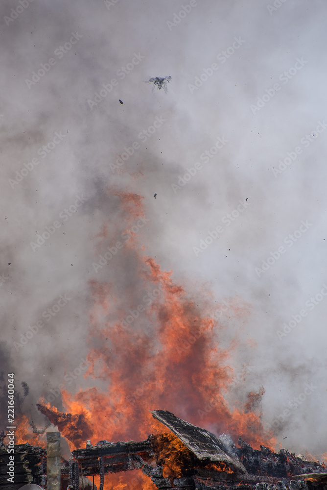 A drone hovers over a raging structure fire
