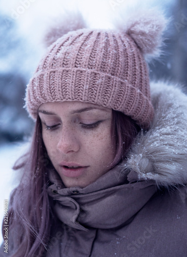 Beautiful young girl at the winter backgroung in village