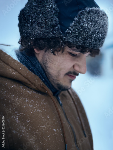 Russian man in winter look and shapka ushanka