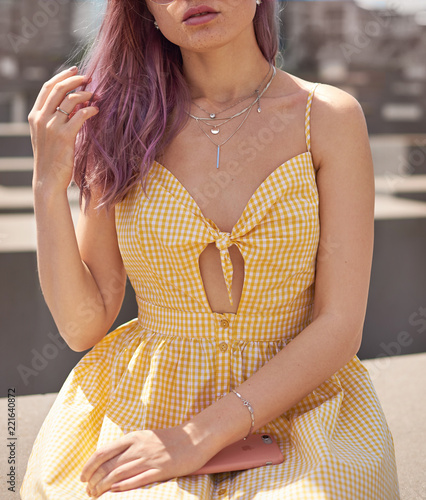 woman in a yellow dress and pink heir