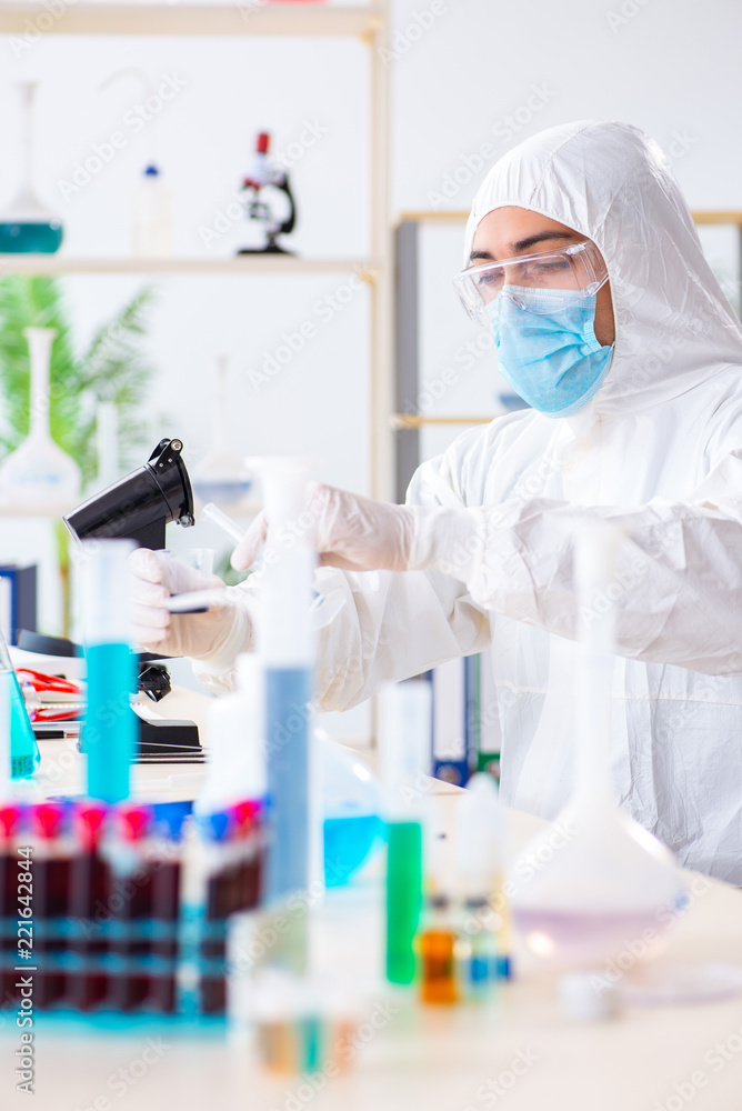 Young chemist student working in lab on chemicals Young chemist student working in lab on chemicals