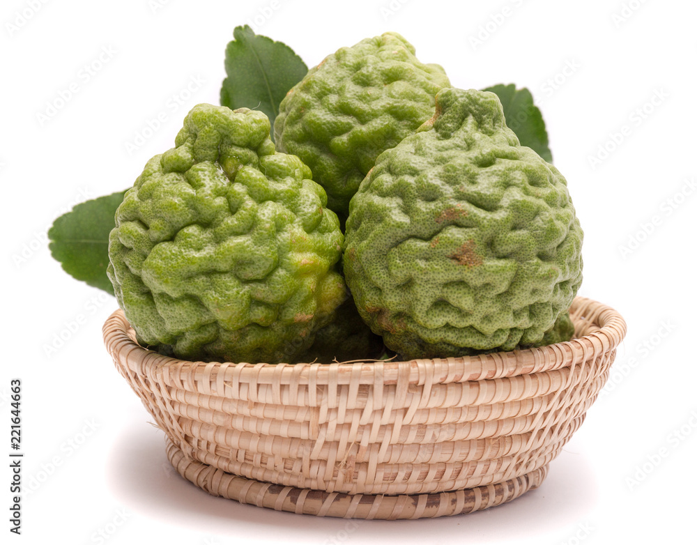Fototapeta premium The kaffir lime leaves in the basket on a white background.
