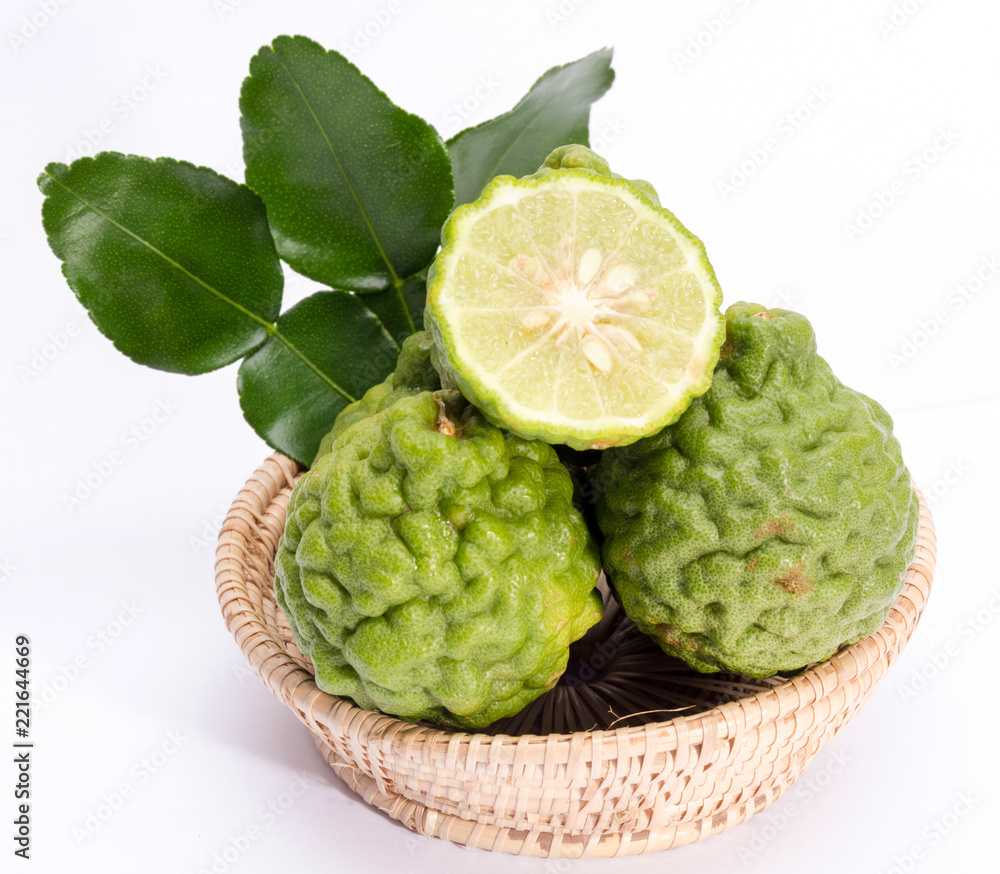 Fototapeta premium The kaffir lime leaves in the basket on a white background.