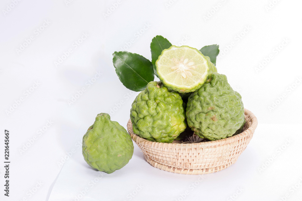 Fototapeta premium The kaffir lime leaves in the basket on a white background.