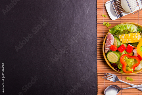 Salad healthy food on wood and black stone background. Weight loss. Copy space.