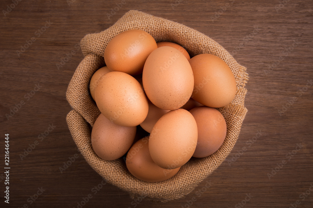 Fresh farm eggs on a wooden rustic background, Whipping eggs and whisk,top view with copy space Fresh farm eggs on a wooden rustic background, Whipping eggs and whisk,top view with copy space