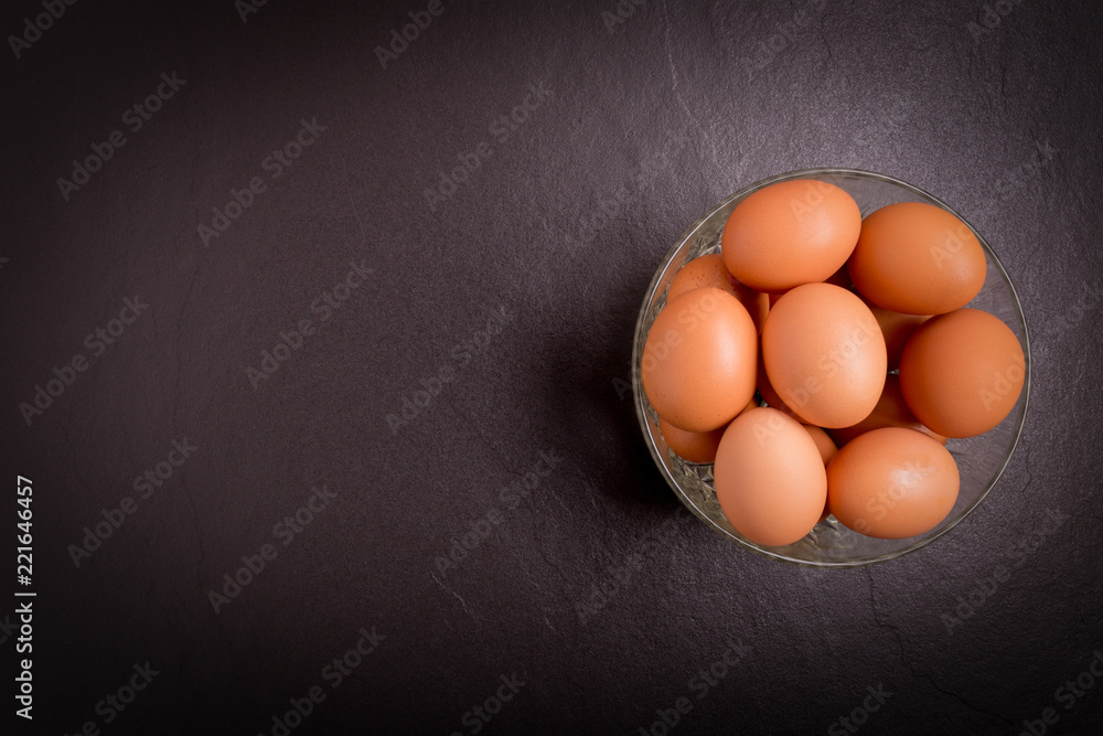 Fresh farm eggs on black stone background,top view with copy space Fresh farm eggs on black stone background,top view with copy space
