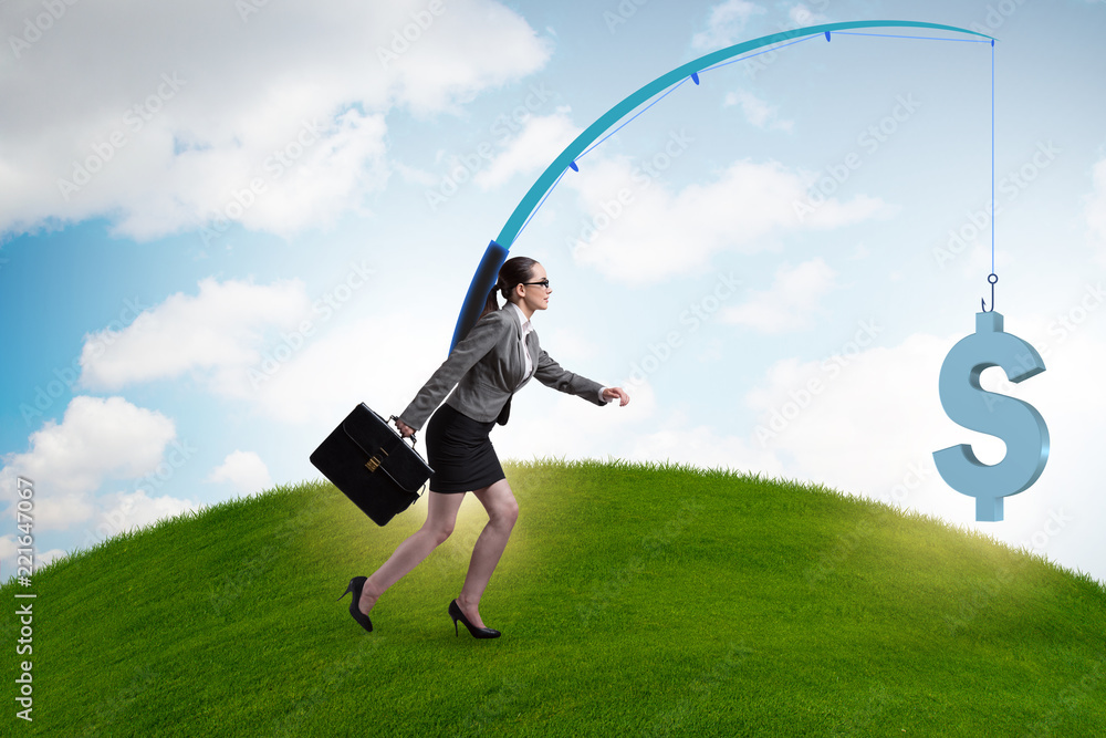 Businesswoman chasing money on fishing rod Businesswoman chasing money on fishing rod