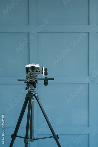 fashion blogging and video streaming. style beauty and trends in social media concept. camera on tripod focusing on clothes on the rack. photo